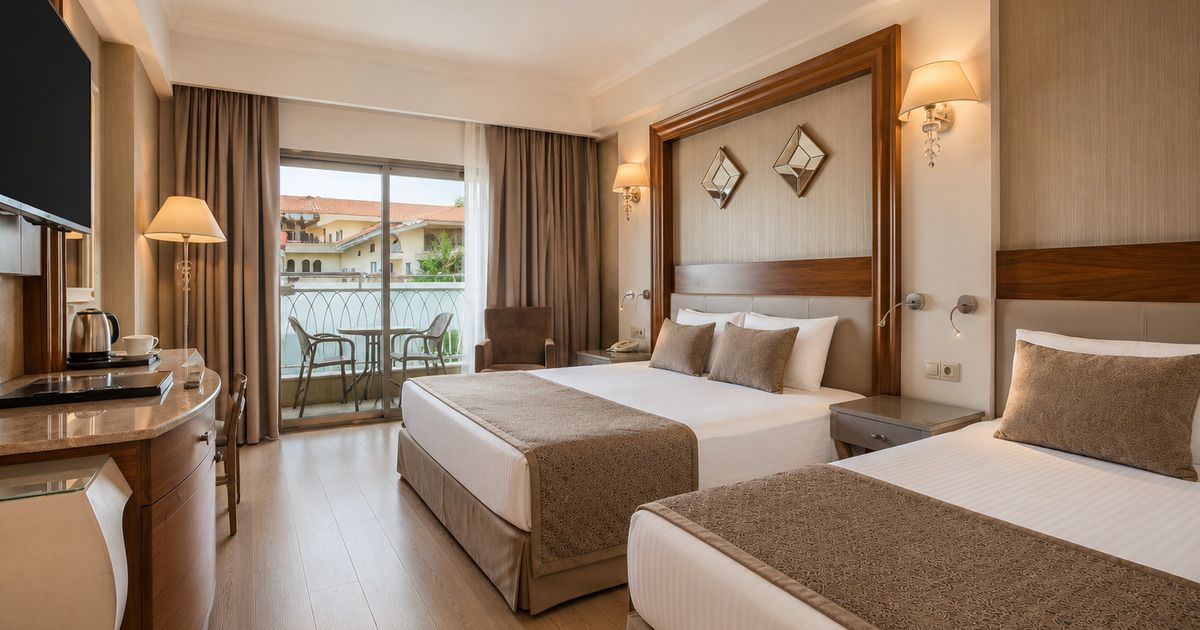 Poolside cabana with white curtains overlooking hotel pool and garden, Side Antalya
