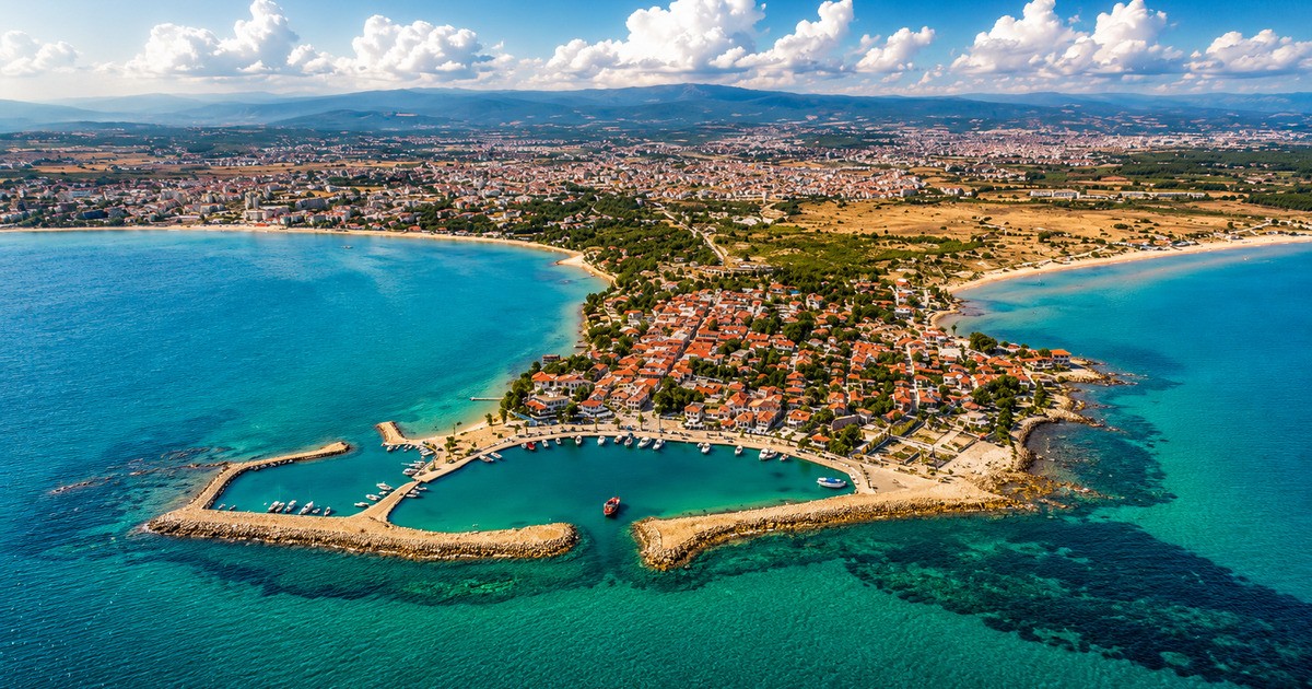 Aerial view of Side peninsula with ancient Roman theatre, terracotta rooftops and turquoise Mediterranean sea