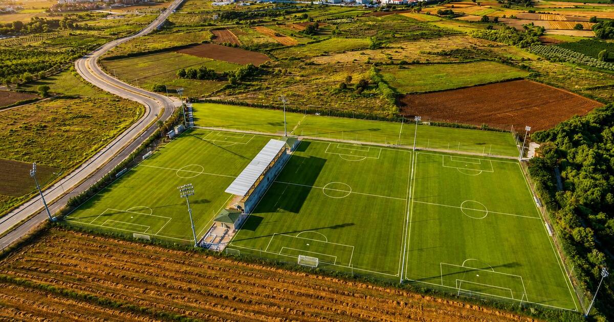 Aerial view of FIFA-standard football training pitches surrounded by countryside near Side, Turkey