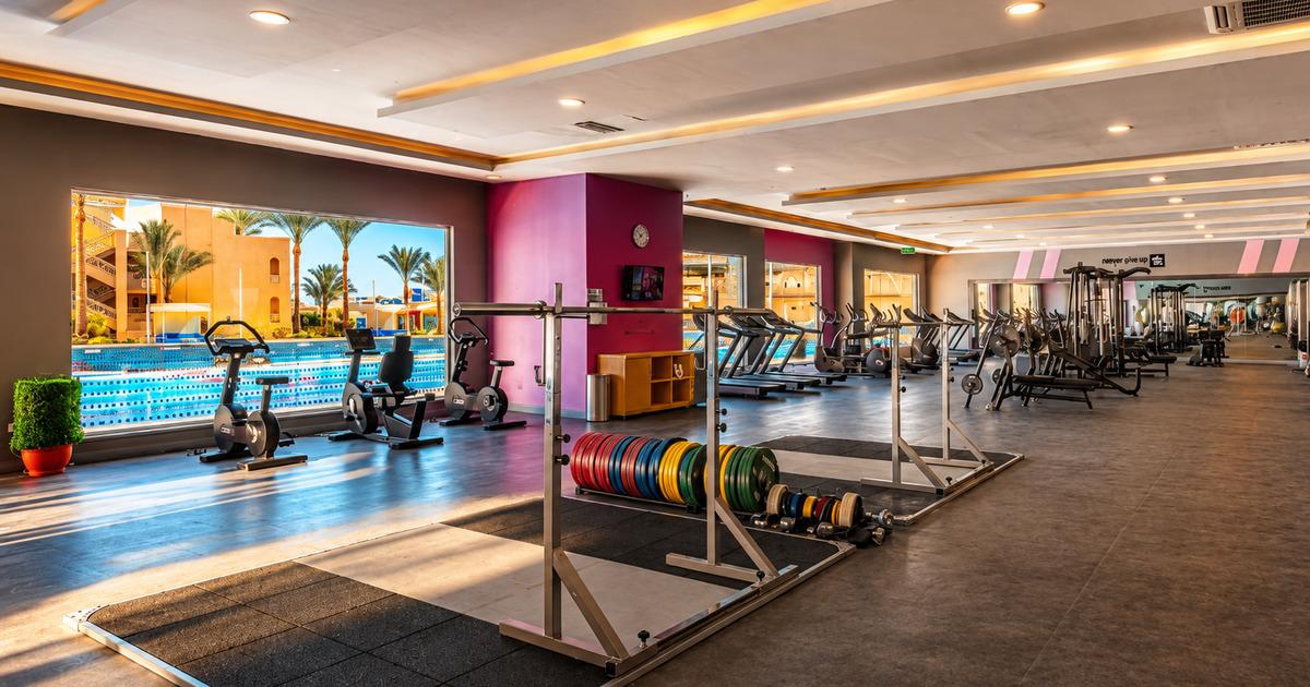 Gym floor with Olympic lifting platforms, bumper plates and barbell storage, resort fitness centre Hurghada