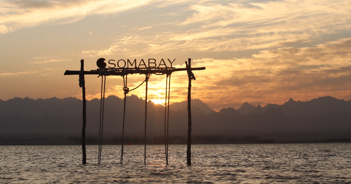 Soma Bay sunset view with Simply Somabay sign reflected in water