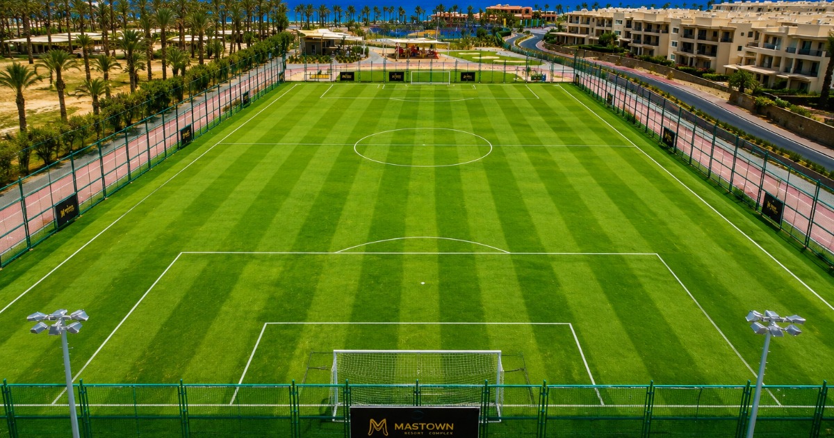 Aerial view of Soma Bay sports complex with natural grass pitch and running track
