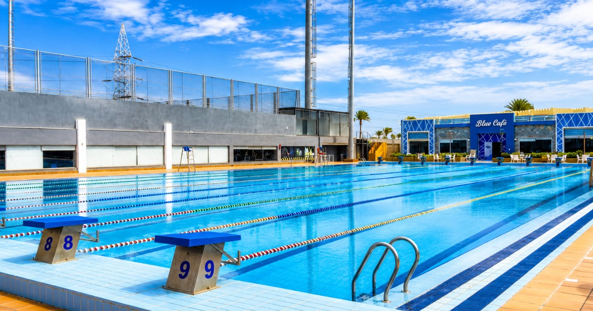 50m outdoor competition pool at purpose-built sports complex in Hurghada, Egypt, with starting blocks, lane ropes, and blue sky